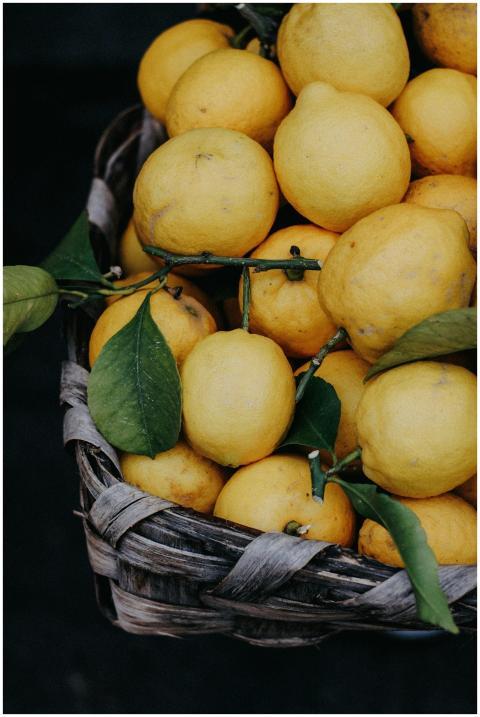 Vibrant yellow lemons in a rustic basket, showcasi