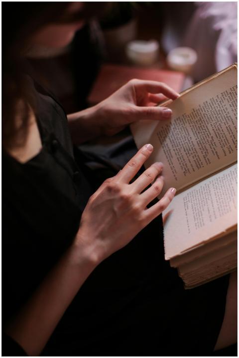 A young woman deeply immersed in a book, creating