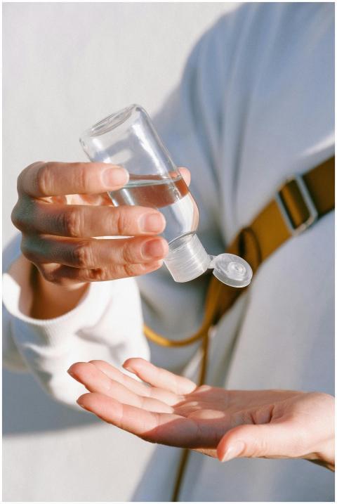 Close-up of a person applying hand sanitizer for h