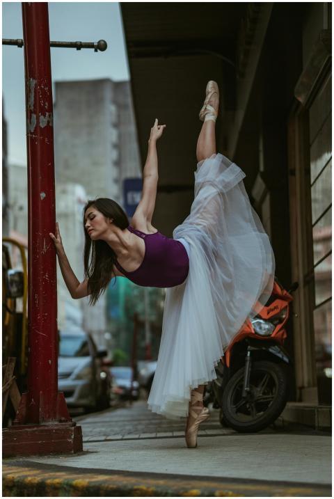 Elegant ballet dancer performs on a street with ur