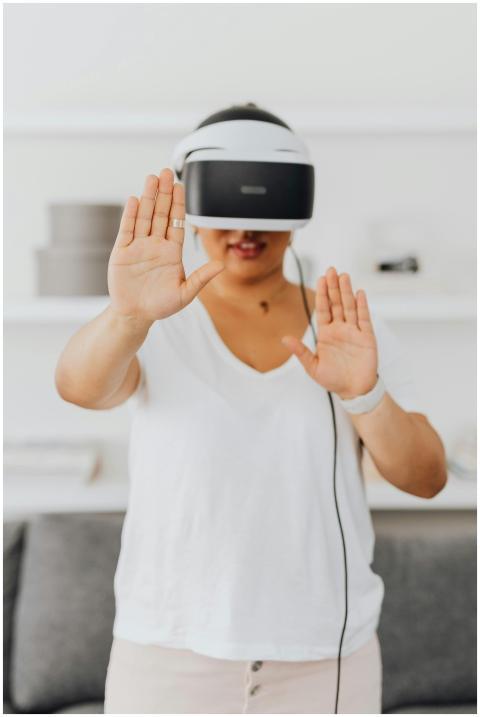Adult woman using VR headset indoors, experiencing