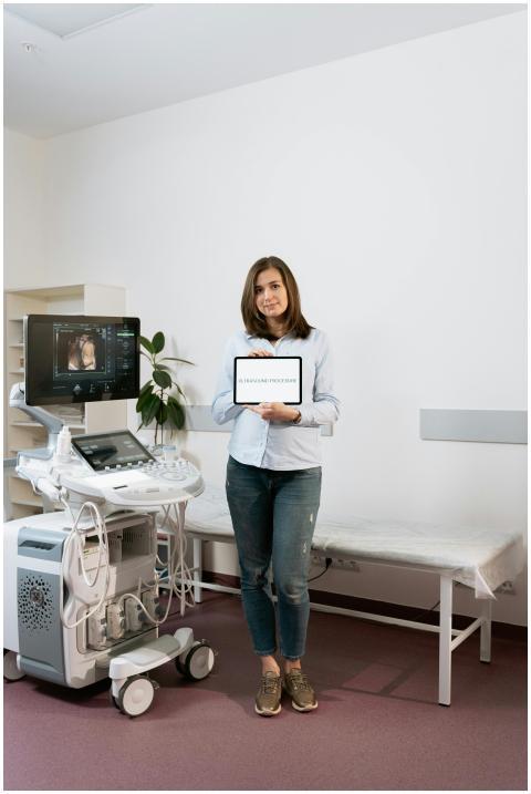 Woman standing with a tablet in a clinic's ultraso