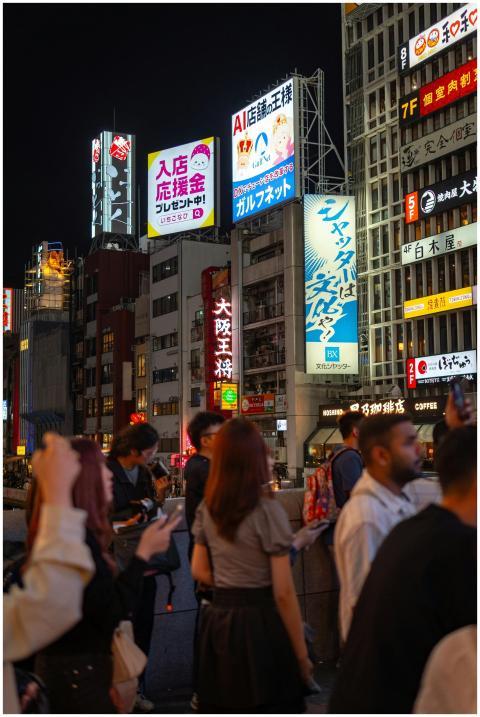 Bustling street in Osaka with illuminated signage