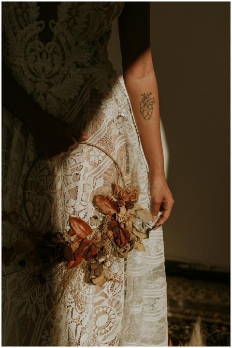 Elegant lace dress contrasted by a delicate tattoo