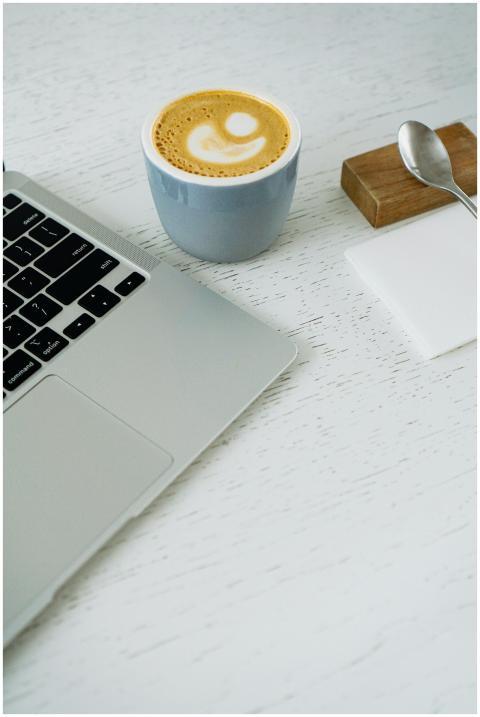Top view of a minimalist workspace with a laptop a
