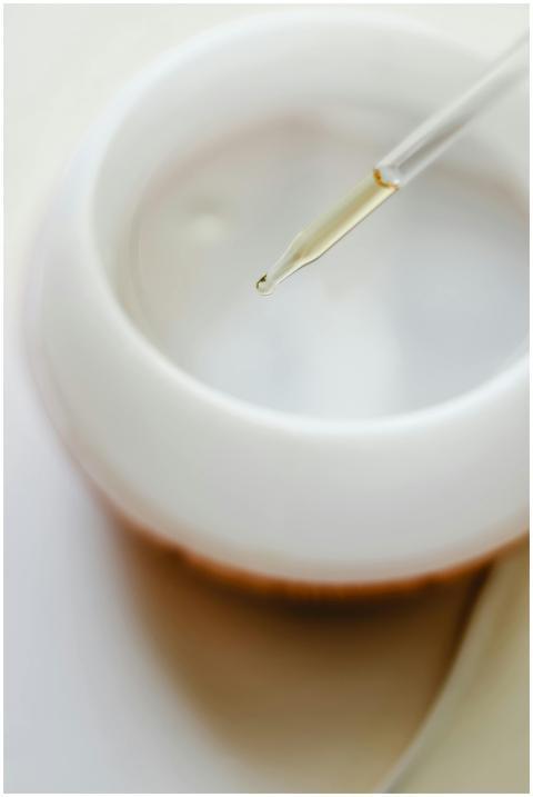 Close-up image of a pipette dispensing essential o
