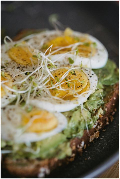 Close-up of an avocado toast topped with hard-boil