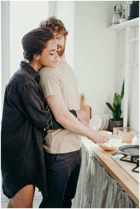 Young couple embracing in a cozy kitchen, sharing