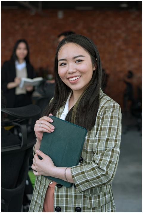 Cheerful businesswoman with a tablet in a modern o