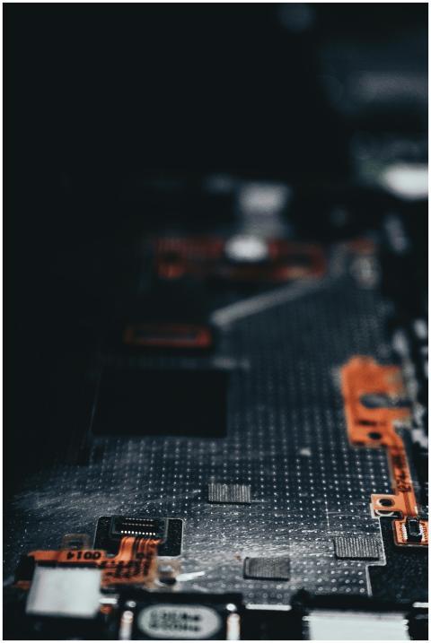 Close-up of a dark circuit board showcasing electr