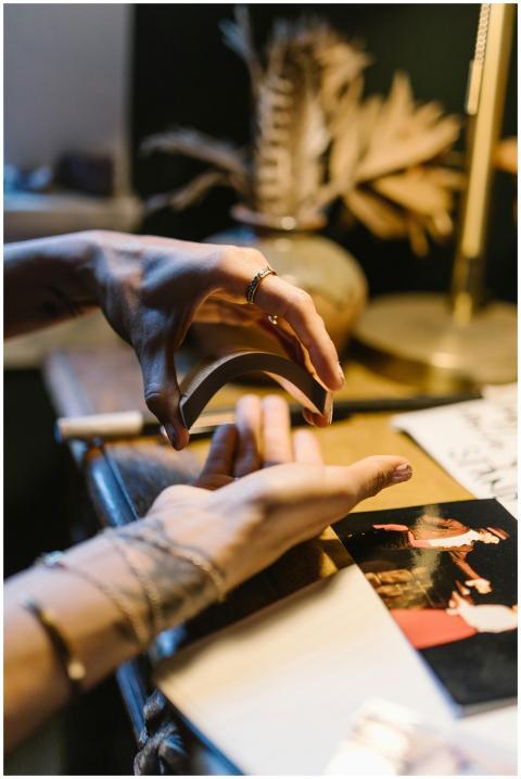 Hands delicately shuffle tarot cards in a mystical