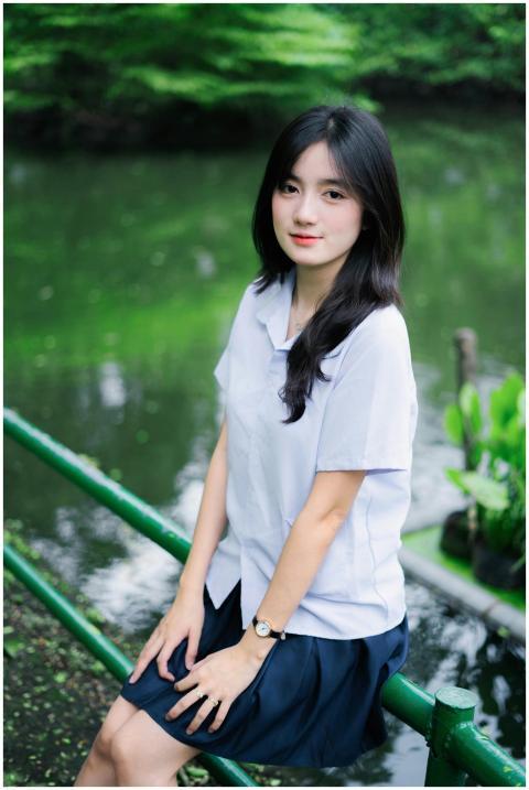 Portrait of a woman in school uniform sitting by a