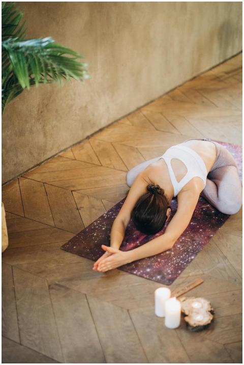 A woman practicing yoga in a serene indoor setting
