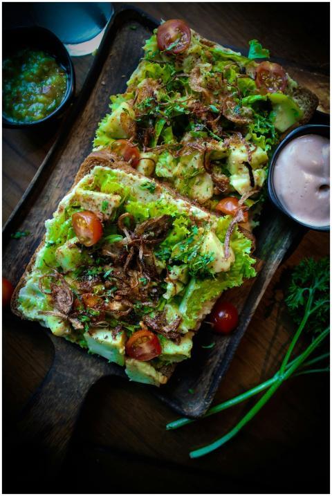 Delicious open sandwich with avocado, cherry tomat