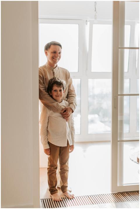 A cheerful father and son duo standing together sh