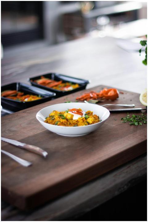 Close-up of a gourmet meal served on a wooden cutt