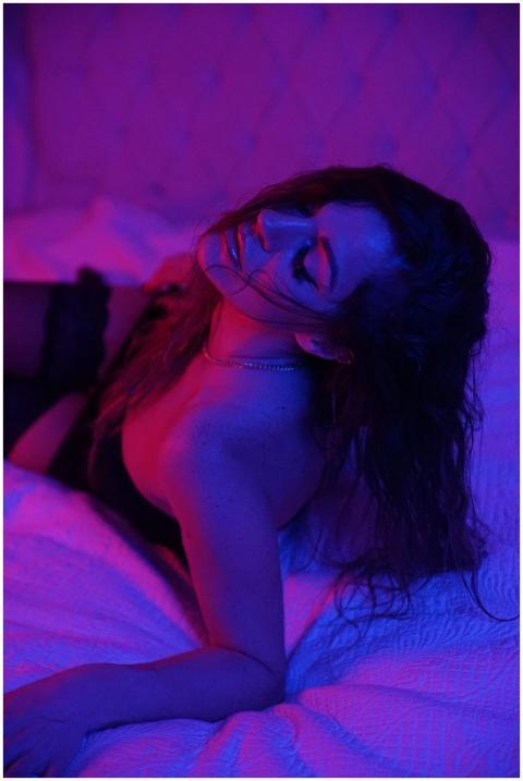 Sensual portrait of a woman under moody blue and r