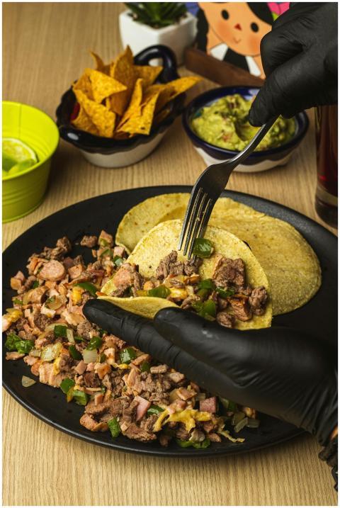 Delicious Mexican street tacos with beef, lime, an