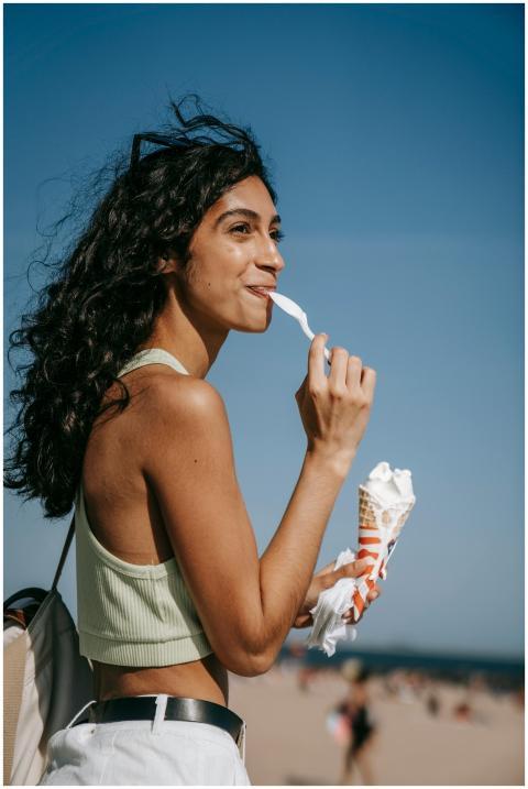 Young woman savoring a vanilla ice cream cone at t