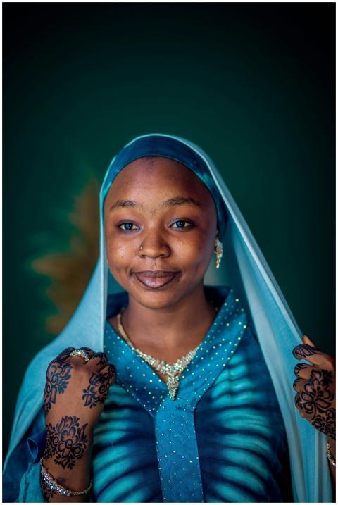 Smiling woman in blue traditional dress and henna,