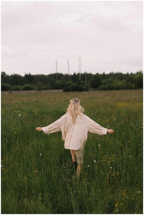 Rear view of a woman with blond hair strolling thr