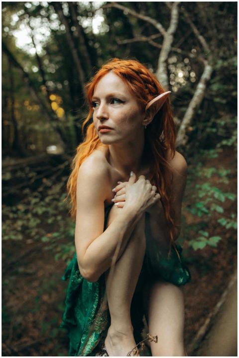 A mystical woman dressed as an elf in a forest, sh