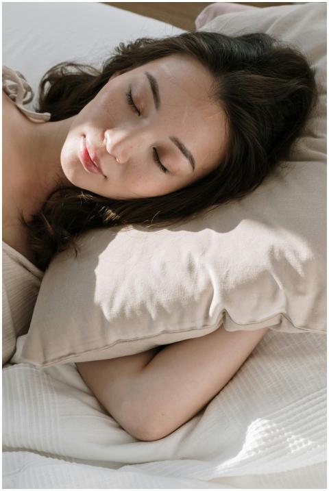 Asian woman sleeping peacefully in morning light w