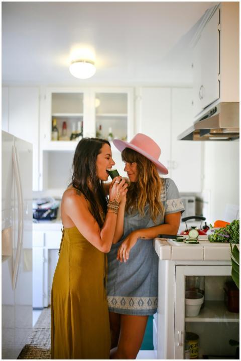 Two women share a lighthearted moment in a kitchen