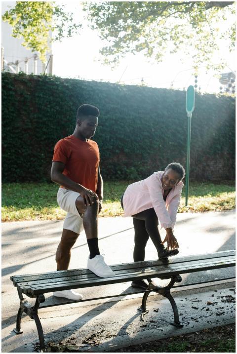 Two adults engage in a morning stretching routine