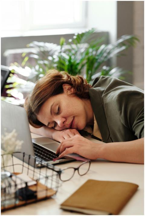Tired woman in home office resting on laptop, illu