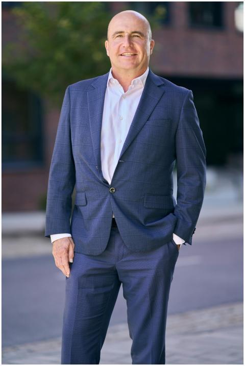 Confident middle-aged businessman in a blue suit s