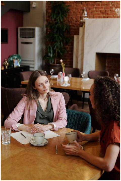 Two women having a thoughtful conversation in a co