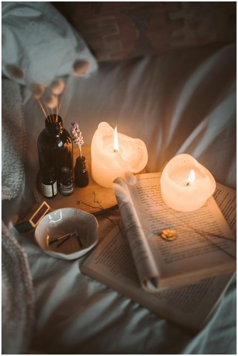 Warm, inviting bedroom setting with candles, books