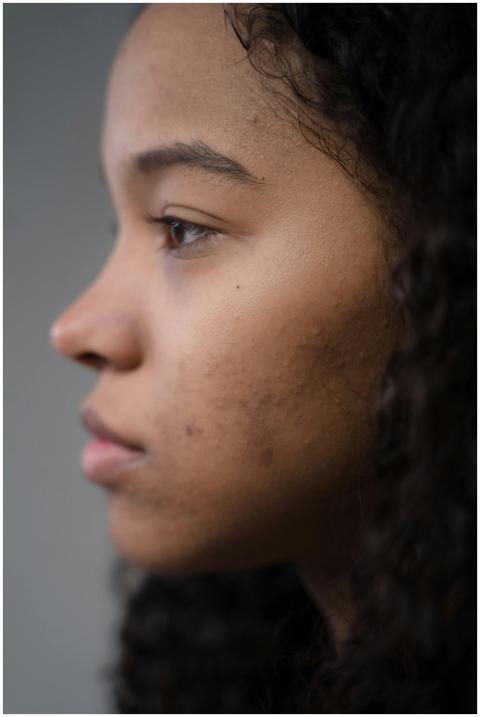 A close-up side profile of a young woman showcasin