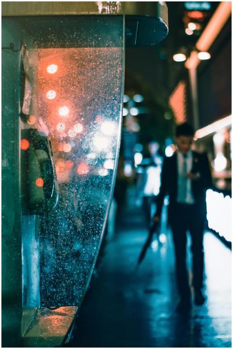 Blurry urban night scene with a businessman walkin