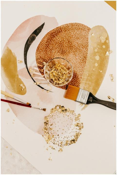 Top view of various paintbrushes and glass with go