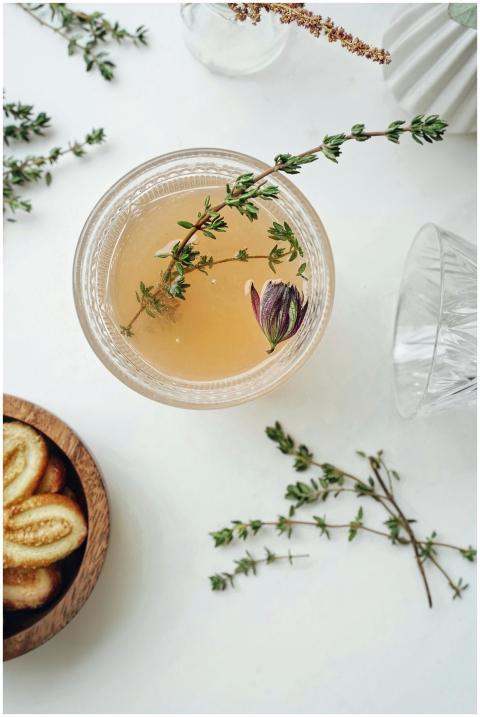 Elegant flatlay of herbal tea garnished with thyme