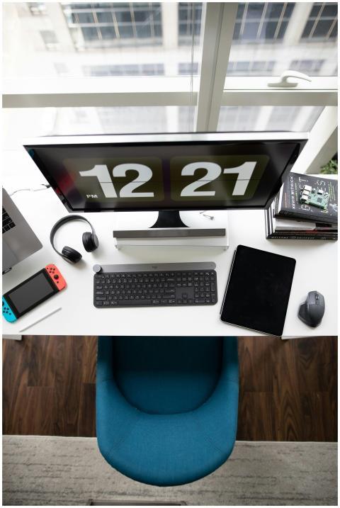 A top view of a modern desk setup featuring a comp