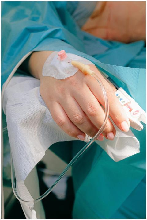 Close-up of a patient's hand receiving intravenous