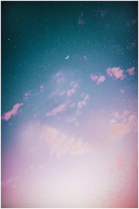 A serene night sky featuring a crescent moon and t