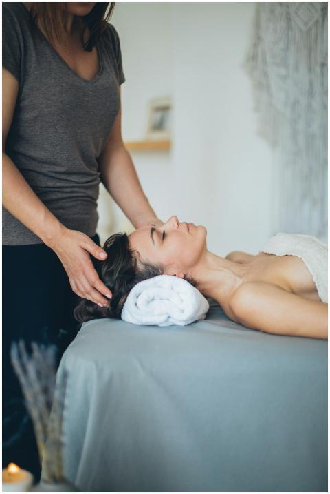 A woman enjoys a soothing head massage at a serene