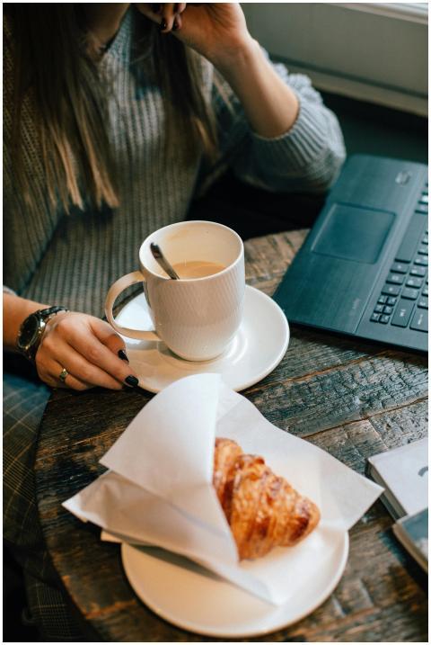 Warm café atmosphere with coffee, croissant, and c