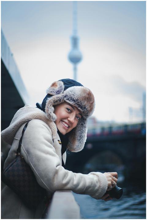 Portrait of a smiling woman in winter attire by a
