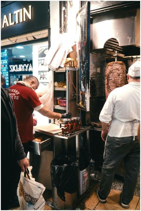 Street vendor preparing doner kebab in a bustling