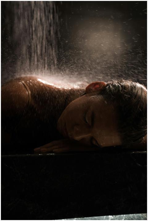 Woman enjoying a soothing shower, highlighting rel