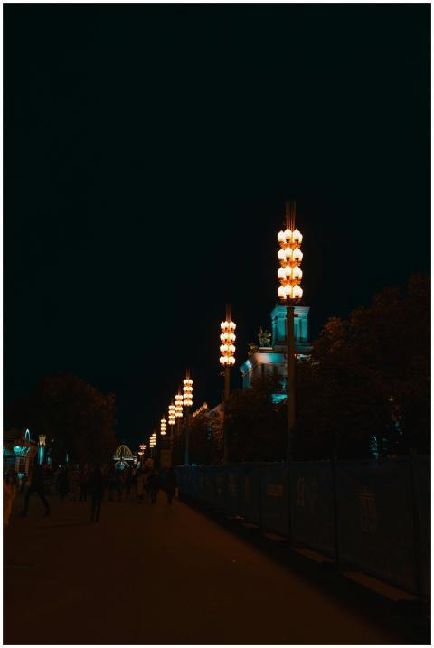 Nighttime city scene with illuminated lanterns alo