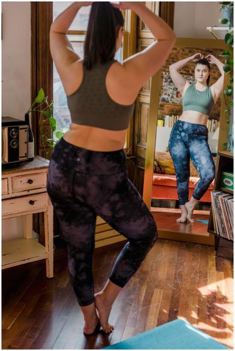 Young woman in activewear poses confidently in fro