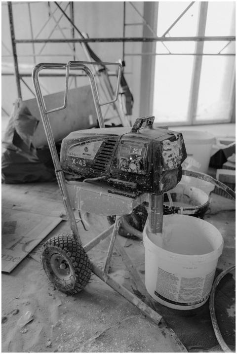 Black and white image of a paint machine on a dust