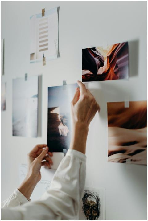 Hands arranging a mood board with various photos o