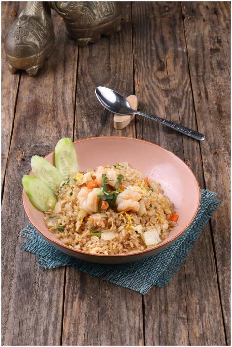 Tasty shrimp fried rice served with cucumber on a